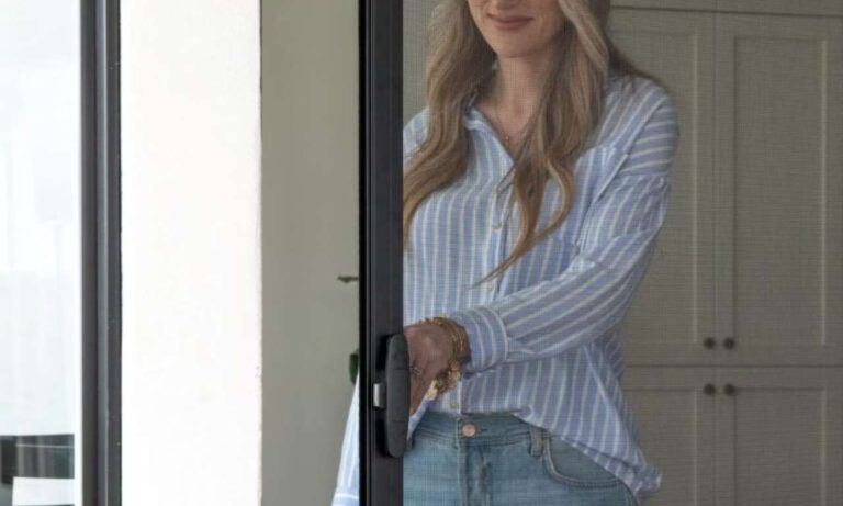 Woman opening retractable screen door